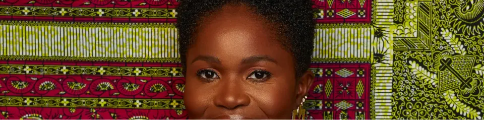 Fatoumata against a green patterned backdrop