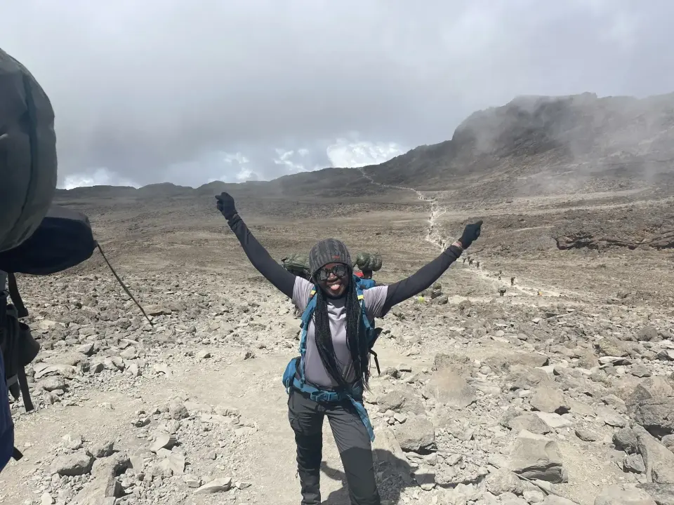 Fatoumata celebrating on Mount Kilimanjaro